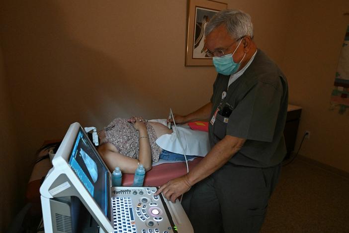 Dr. Franz Theard performs a sonogram on a patient seeking abortion services at the Women's Reproductive Clinic in Santa Teresa, New Mexico, a state that has not banned abortions.