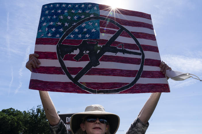 FILE - A protestor holds a sign during a Students Demand Action event, near the U.S. Capitol, Monday, June 6, 2022, in Washington.