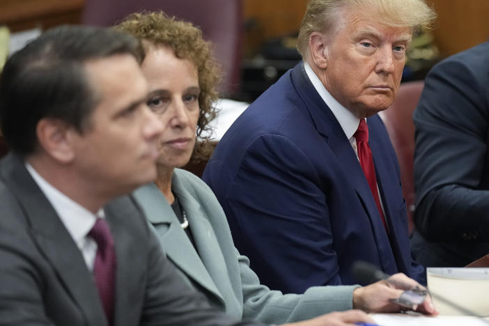 Former President Donald Trump sits at the defense table with his legal team in a Manhattan court, Tuesday, April 4, 2023, in New York.