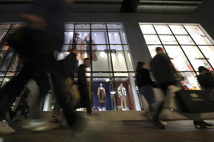 People walk past a store in Berlin on Oct. 11, 2022. The German economy shrank unexpectedly in the first three months of this year.