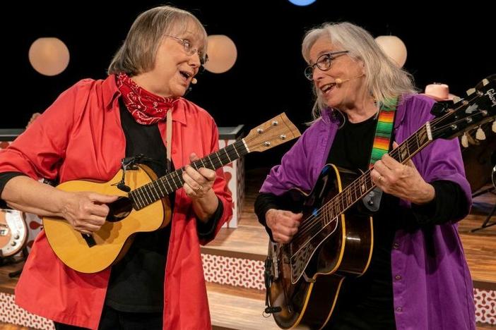 Grammy Award-winning musicians Marcy Marxer and Cathy Fink sing about the unexpected humor they encountered during Marxer's seven-year fight with breast cancer in the concert film, <em>All Wigged Out</em>.