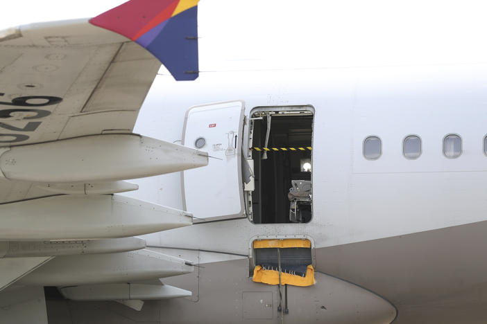 An Asiana Airlines plane is parked as one of the plane's doors suddenly opened at Daegu International Airport in Daegu, South Korea, Friday, May 26, 2023.