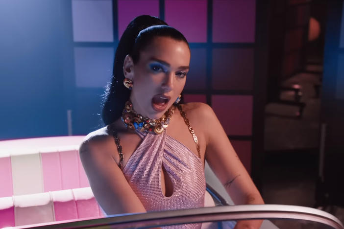 Dua Lipa in the "Dance the Night" video, seated in the Barbie car.