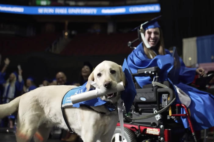 Seton Hall University gave Grace Mariani's service dog, Justin, a special doggie diploma this week, to the delight of Mariani and her fellow graduates.