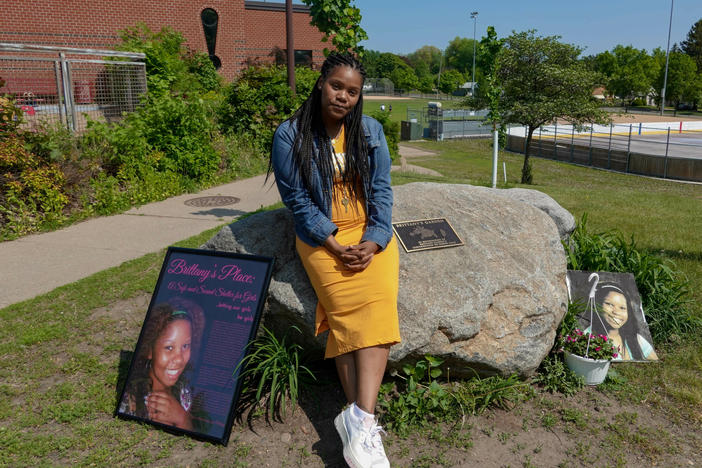 Lakeisha Lee placed flowers at the base of a monument honoring her late sister Brittany Clardy Thursday, May 26, in Saint Paul. Clardy went missing more than a decade ago and was found murdered.