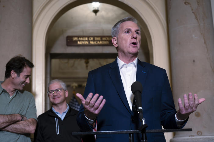 Speaker of the House Kevin McCarthy, R-Calif., is joined by his top negotiators on the debt limit, Rep. Garret Graves, R-La., left, and Rep. Patrick McHenry, R-N.C., chairman of the House Financial Services Committee, as he talks to reporters at the Capitol on Sunday.