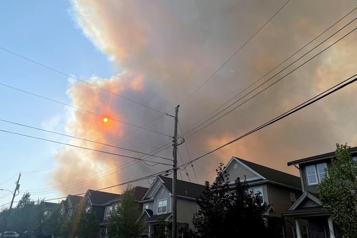 Smoke from the Tantallon wildfire rises over houses in nearby Bedford, Nova Scotia, Canada, on Sunday.