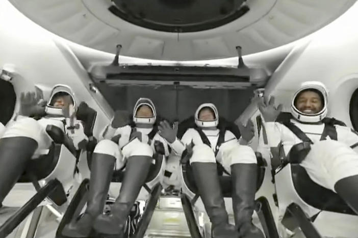 In this image taken from video broadcast by SpaceX, crew members wave after the SpaceX Dragon capsule splashed down into the Gulf of Mexico, just off the Florida Panhandle, late Tuesday, May 30, 2023.