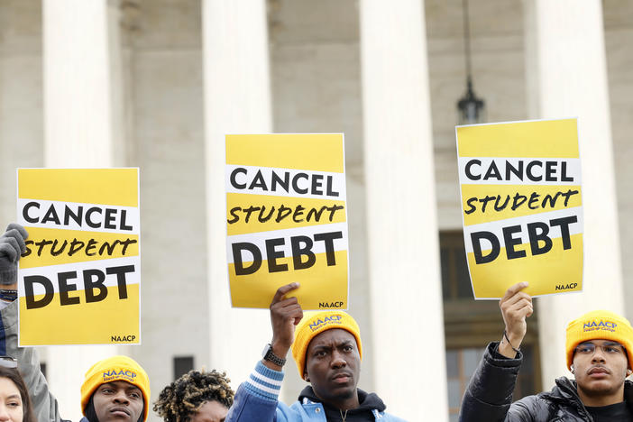 Student loan borrowers gather outside the Supreme Court building in February 2023. The court's ruling on President Biden's debt relief plan is expected in June or July.