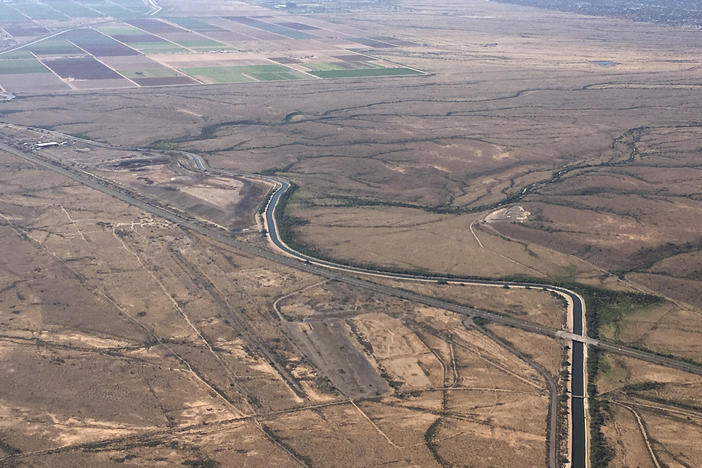 In this Oct. 8, 2019, file photo, the Central Arizona Project canal runs through rural desert near Phoenix. The canal diverts Colorado River water down a 336-mile long system of aqueducts, tunnels, pumping plants and pipelines to the state of Arizona.