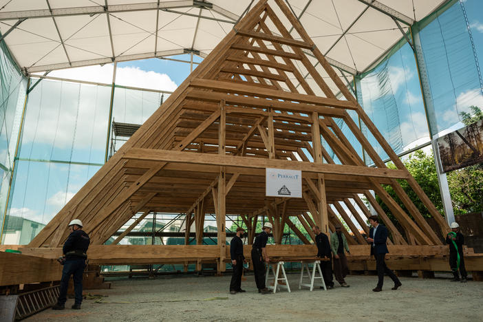 Carpenters at the Ateliers Perrault finalize the practice assembly of the <em>charpente</em>, or roof framework of the choir — the part of the cathedral that provides seating for the clergy and choir — on May 25. It extends nearly 50 feet long by 33 feet high.