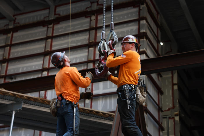 Construction workers prepare steel for a crane at the site of JPMorgan Chase's new headquarters in New York City on May 18, 2023. Builders added jobs this month despite the headwinds from higher interest rates. It was another indication of the country's strong job market.