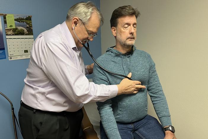 Osteopathic physician Kevin de Regnier of Winterset, Iowa, checks Chris Bourne, who came in for an adjustment of his anxiety medication on May 9, 2023.