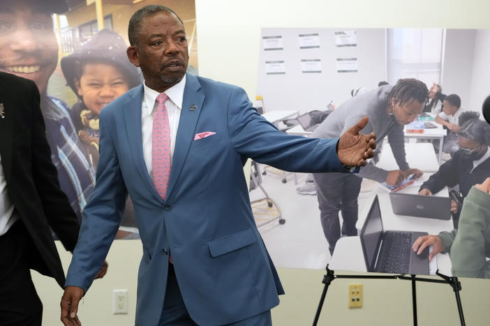 Lawyers Benjamin Crump, left, and Carl Douglas, right, held a news conference in January to announce their filing of a $50 million claim against the city of Los Angeles over the death of Keenan Anderson, who is pictured on posters.