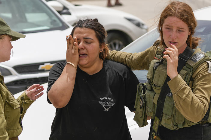 An Israeli soldier cries outside a military base following a deadly shootout in southern Israel along the Egyptian border on Saturday.