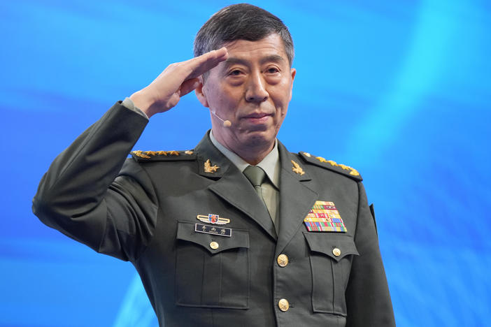 Chinese Defense Minister Li Shangfu salutes before delivering his speech on the last day of the 20th International Institute for Strategic Studies (IISS) Shangri-La Dialogue, Asia's annual defense and security forum, in Singapore, Sunday, June 4, 2023.