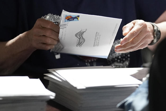 An election worker continues the process of counting ballots for the 2022 Pennsylvania primary election in Mercer, Pa.