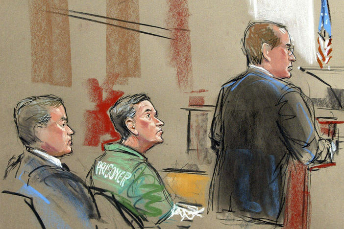 In this artist depiction, U.S. Attorney Randy Bellows, right, addresses the court during the sentencing of convicted spy Robert Hanssen, center, seen with his attorney Plato Cacheris, left, at the federal courthouse in Alexandria, Va., May 10, 2002.