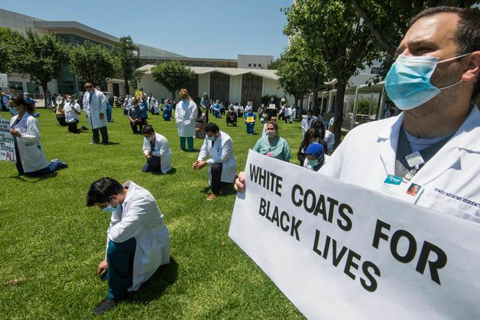 It's still early days for AI in health care, but already racial bias has been found in some of the tools. Here, health care professionals at a hospital in California protest racial injustice after the murder of George Floyd.