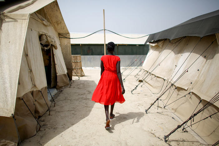 A woman walks between tents that house the hospital wards at a camp for displaced persons in South Sudan. The photo was taken in February.