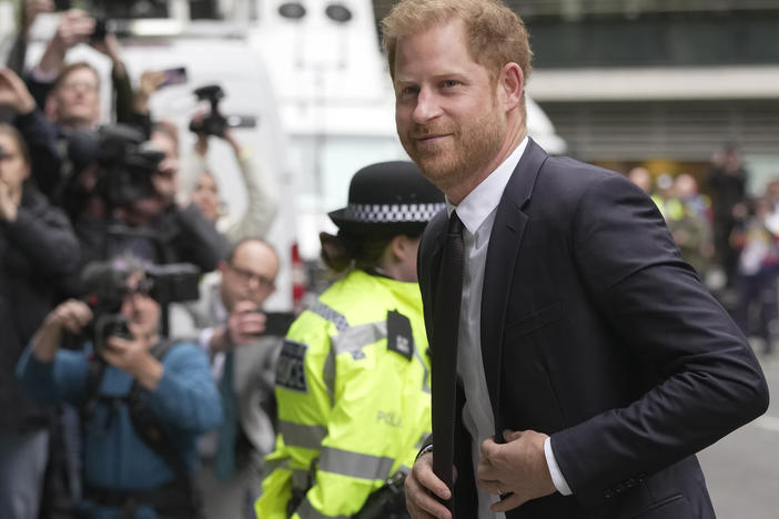 Prince Harry arrives at the High Court in London on Tuesday to testify against a tabloid publisher he accuses of phone hacking and other unlawful snooping.