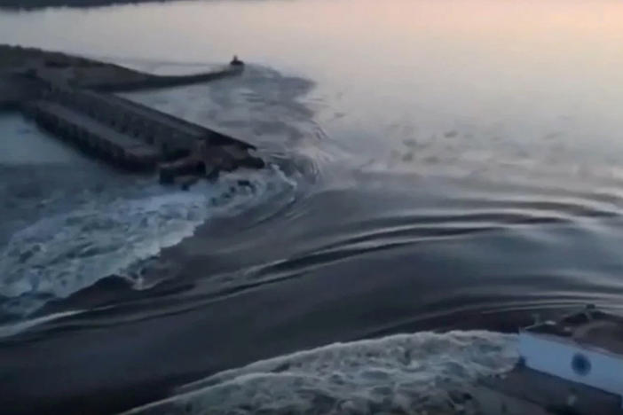 In a photo taken from video released by the Ukrainian Presidential Office, water surges through a break in the Kakhovka dam in southern Ukraine. Ukraine and Russia are both accusing each other of blowing up the dam, which also destroyed an attached hydroelectric power station.