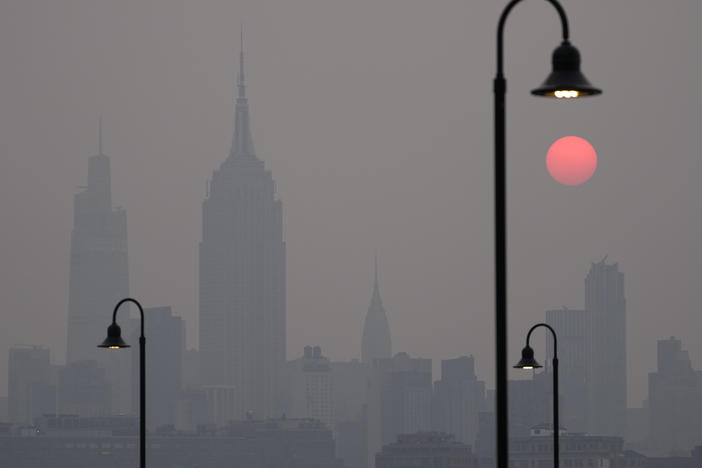 The sun rises over a hazy New York City skyline as seen from Jersey City, N.J., Wednesday, June 7, 2023. Intense Canadian wildfires are blanketing the northeastern U.S. in a haze, turning the air acrid, the sky yellowish gray and prompting warnings for vulnerable populations to stay inside.