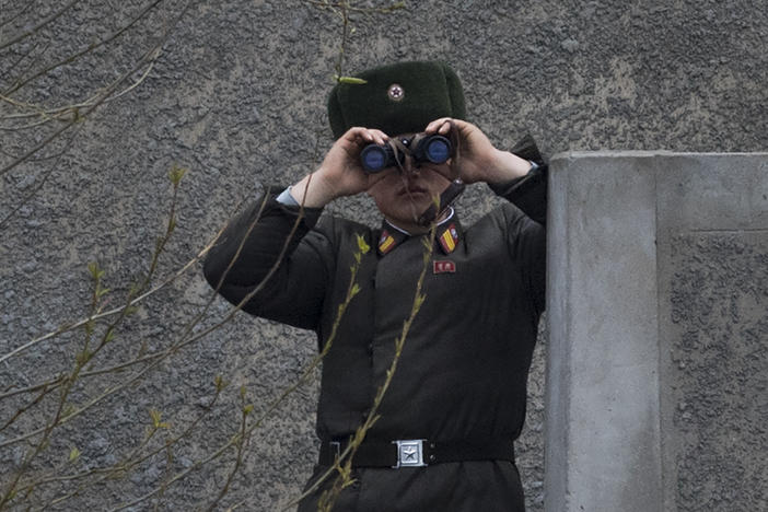 A North Korean soldier looks across the Yalu river near Sinuiju, opposite the Chinese border city of Dandong in April 2017.