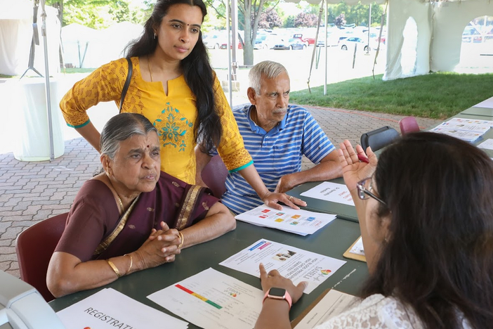 Attendees at a health fair at the  Balaji Temple, in Aurora, Ill., learn about the SAHELI diabetes prevention program.