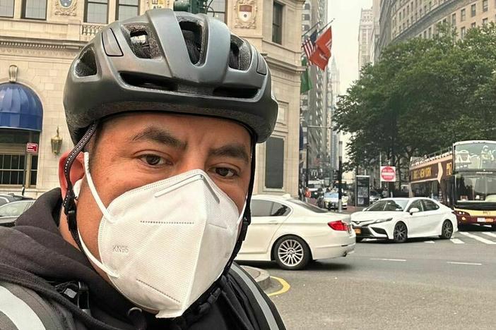Gustavo Ajche snapped a selfie on the street while making his rounds on Wednesday.