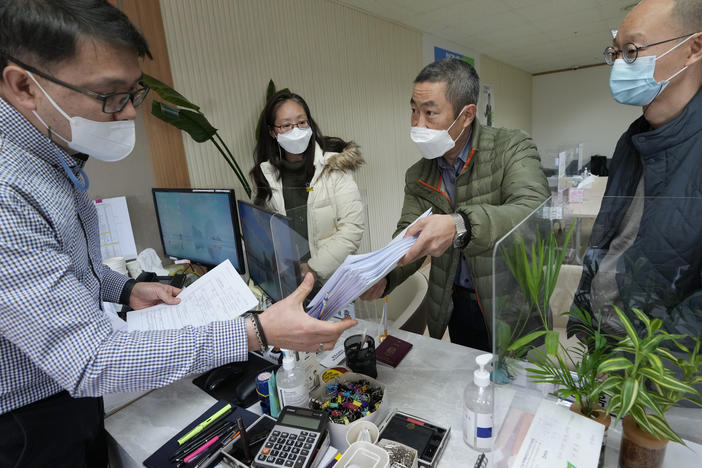 Peter Møller, second from right, attorney and co-founder of the Danish Korean Rights Group, submits the documents at the Truth and Reconciliation Commission in Seoul, South Korea, Nov. 15, 2022.