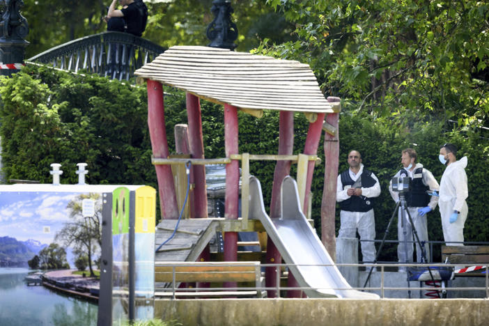 Security forces gather in a playground at the scene of knife attack in Annecy, a town in the French Alps, on Thursday.