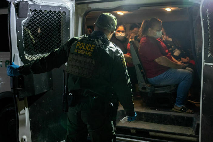 Venezuelan migrants board a U.S. Border Patrol vehicle after crossing the Rio Grande River on May 18, 2021, in Del Rio, Texas.