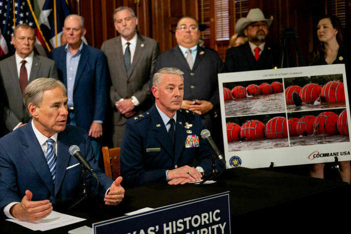 Texas Gov. Greg Abbott (left) speaks about a new border security measure during a news conference at the Texas State Capitol on June 8.
