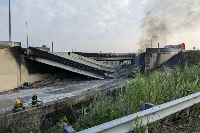 Firefighters work near a section of I-95 in Philadelphia that collapsed Sunday following a vehicle fire.