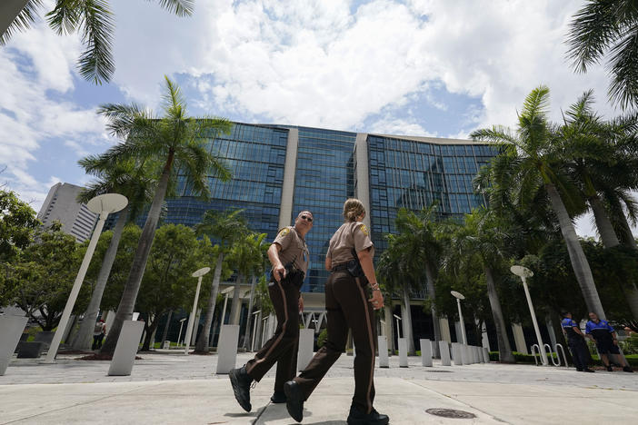 Miami-Dade Sheriff deputies walk in front of the Wilkie D. Ferguson Jr. federal courthouse building in Miami on Friday.