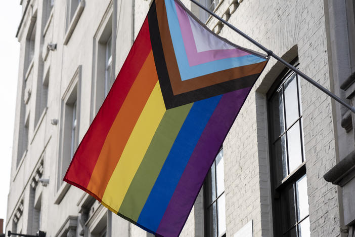 A pride progress flag hangs on a building in November 2022 in London.