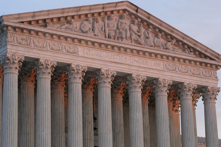 The setting sun illuminates the Supreme Court building on Capitol Hill in Washington on Jan. 10, 2023.