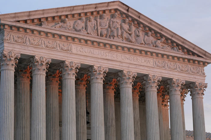 The setting sun illuminates the Supreme Court building in Washington on Jan. 10.