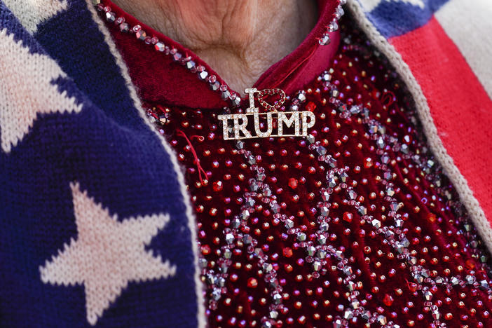A supporter of former President Donald Trump wears an "I Love Trump" pin while waiting for him to speak at Trump National Golf Club in Bedminster, N.J., Tuesday.