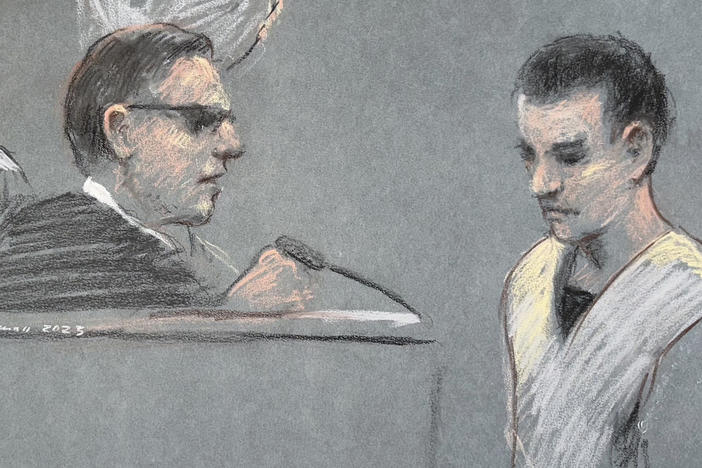 This artist depiction shows Massachusetts Air National Guardsman Jack Teixeira, right, appearing in U.S. District Court in Boston, April 14, 2023. Teixeira has been indicted on federal felony charges. The Justice Department says Teixeira faces six counts in the indictment of willful retention and transmission of national defense information.