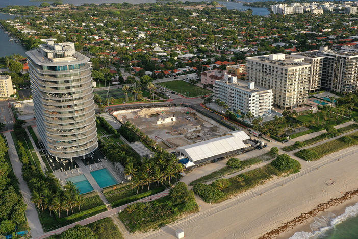 In an aerial view, a cleared lot where the 12-story Champlain Towers South condo building once stood is seen on June 22, 2022, in Surfside, Fla., a year after the tragic event where 98 people died when the building partially collapsed in 2021.