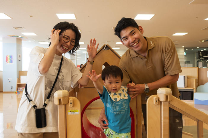 Taiki and Arisa Chisaka watch as their son Tatara plays at a city-run child care center in western Japan's Akashi city.