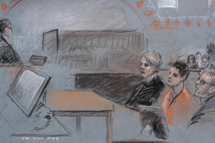 In this artist depiction, Massachusetts Air National Guardsman Jack Teixeira, seated second from right, appears in U.S. District Court, in Boston, April 19, 2023. Teixeira, accused of leaking highly classified military documents on a social media platform, is due back in court on June 21, after being indicted on federal felony charges.