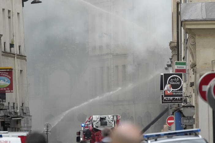Firemen use a water canon as they fight a blaze following an explosion on Wednesday in Paris.