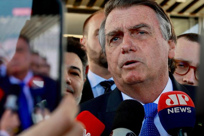 Brazil's former President Jair Bolsonaro speaks to the press as he leaves the Federal Senate in Brasília on June 21.