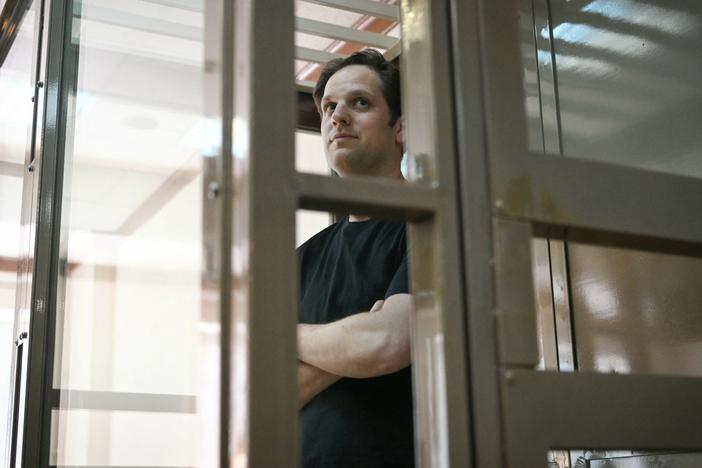 Evan Gershkovich, the U.S. reporter detained on espionage charges in Russia, stands inside a defendants' cage before a hearing to consider an appeal of his extended detention at the Moscow City Court. His appeal was rejected.