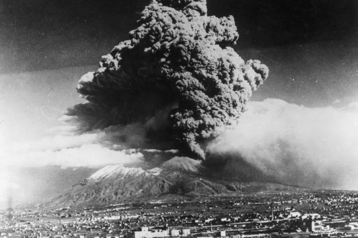 March 1944: A cloud of ash hangs over Vesuvius during its worst eruption in more than 70 years. In the foreground is the city of Naples. The nearby towns of Massa and San Sebastiano were destroyed by the flow of lava. (Photo by Keystone/Getty Images)