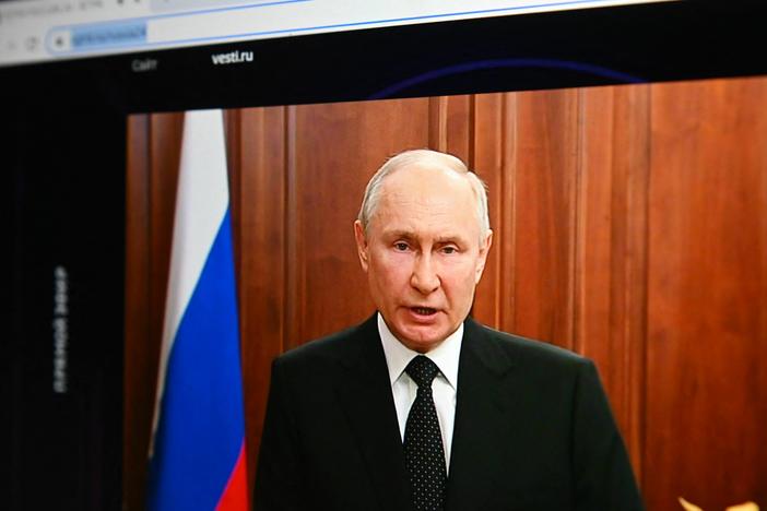 Russia's President Vladimir Putin, seen on a laptop screen, makes a statement in Moscow on Saturday as Wagner Group forces stage a rebellion.