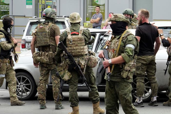 Members of Wagner Group inspect a car in a street of Rostov-on-Don, Russia, on Saturday.